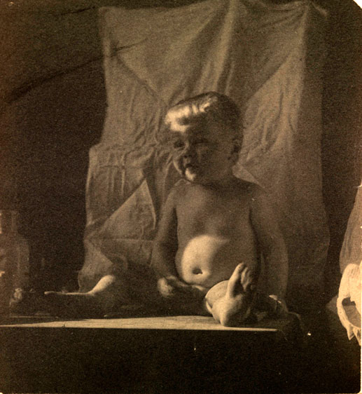 Boy nude, sitting on table in front of light backdrop (Нагой мальчик, сидящий на столе перед светлым фоном), c.1885