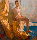 Portrait of a seated boy in front of fabric drapery