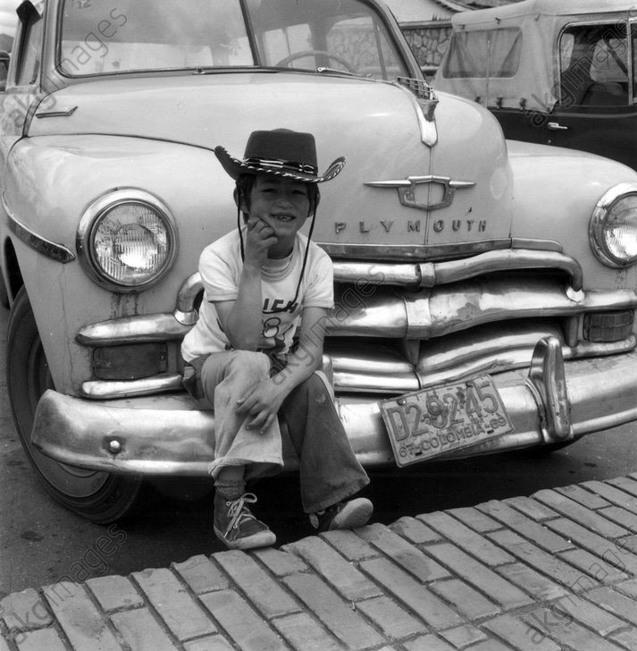 Little boy with cowboy hat sitting on the bumper of a car (Мальчик в ковбойской шляпе, сидящий на бампере автомобиля), c.1960s