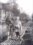 A shepherd with a shepherd boy on the main street of the village