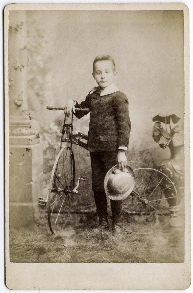 Young boy with tricycle, holding his hat (Мальчик с трициклом, держит шляпу), c.1890