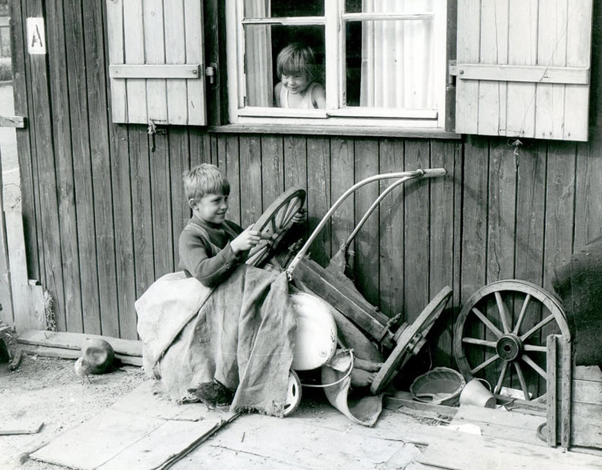 A refugee boy waits for resettlement in a refugee camp in Germany (Мальчик-беженец, ожидающий переселения в лагере беженцев в Германии), 1945