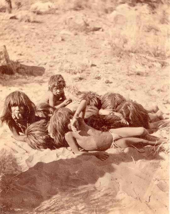 Group of boys huddled on the ground playing a game? (Группа мальчиков, сгрудившихся на земле, играющих в игру?), 1870s