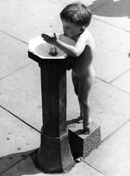 A naked boy drinks at the tap of a street fountain (Голый мальчик, пьющий у уличного фонтанчика), 27 May 1937 