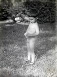 Boy with a children's watering can / Мальчик с детской лейкой