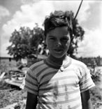 Acadian boy wearing religious medal / Акадский мальчик с религиозной медалью