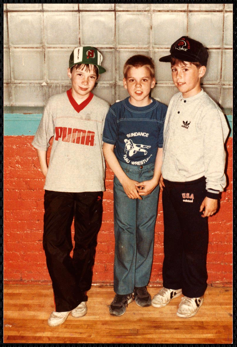 Three boys standing in front of a wall at an open house event (Три мальчика, стоящие перед стеной на мероприятии «День открытых дверей»), 1987