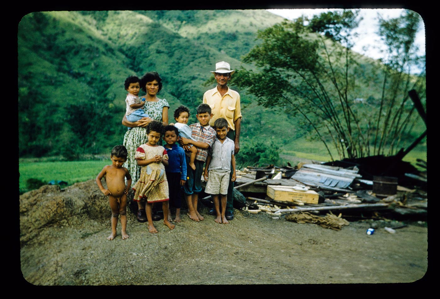 Family standing by remains of house after Hurricane Betsy (Семья стоит у руин дома после урагана Бетси), 1956