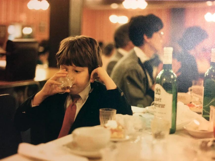 Boy stealing a drink of wine at a wedding while his mom isn’t looking (Мальчик украдкой пьёт вино на свадьбе, пока не видит его мать), 1987