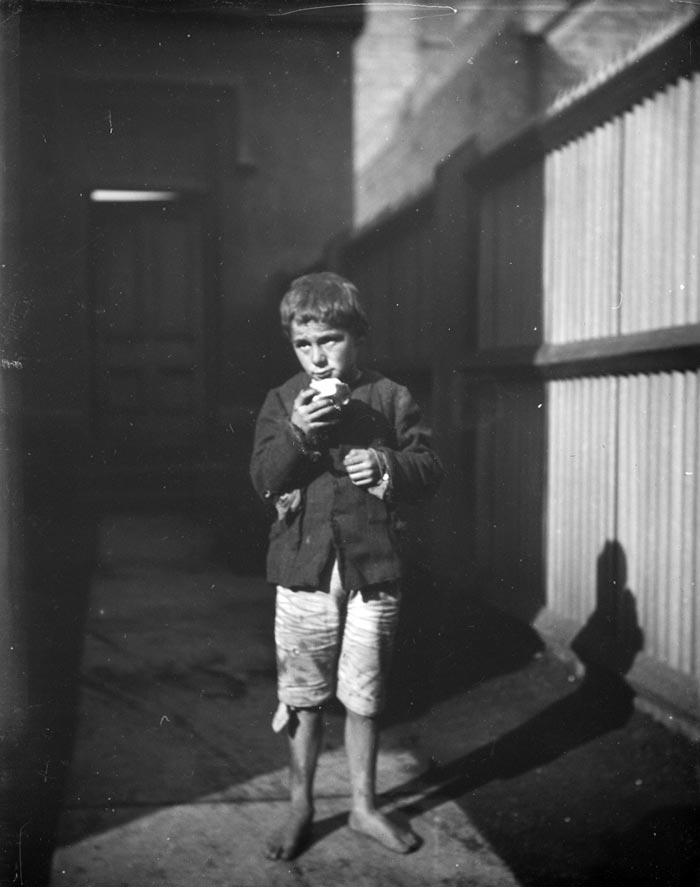 [Boy, standing on path, wearing old and dirty clothes, no shoes, holding an apple / Мальчик стоит на тропинке, в старой и грязной одежде, без обуви, держит яблоко]