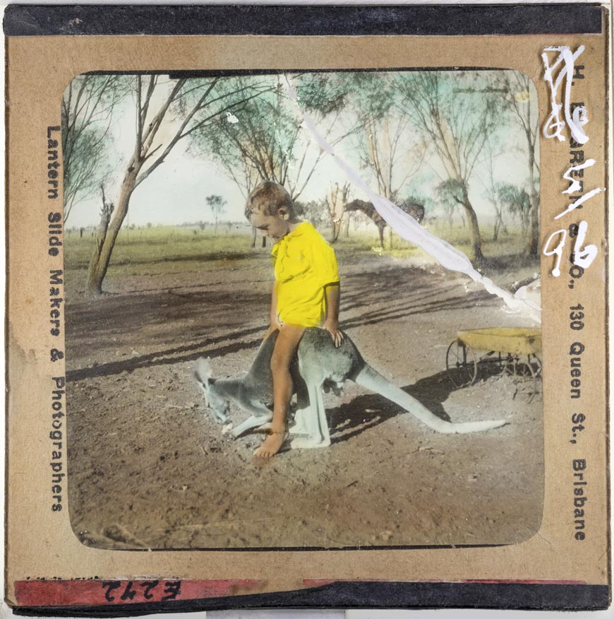 Small boy sitting on a young kangaroo (Маленький мальчик сидит на детёныше кенгуру.), c.1937
