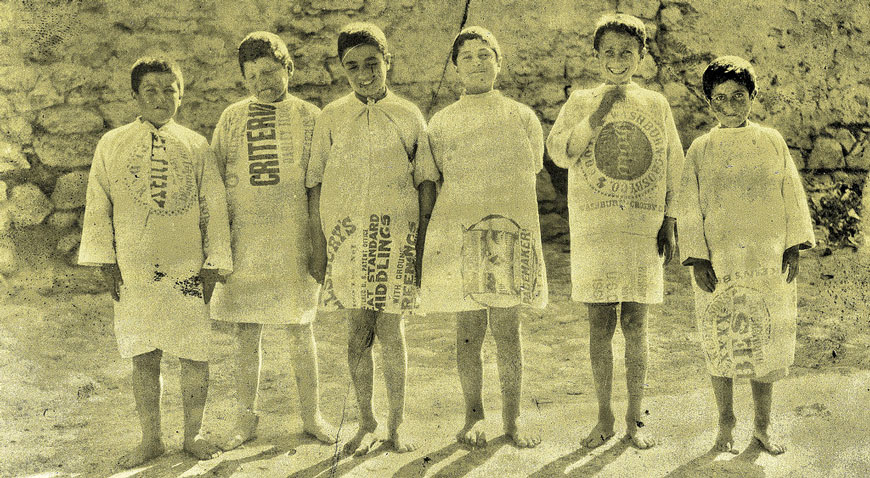 Refugee Armenian and Syrian boys dressed in American flour sacks (Армянские и сирийские мальчики-беженцы, одетые в американские мешки из-под муки), c.1920