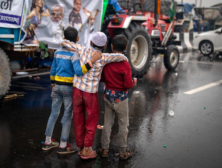 Young Indian boys look at posters critical of Indian government at a site of protest against new farm laws (Индийские мальчики смотрят на плакаты с критикой правительства Индии на месте протеста против новых сельскохозяйственных законов), 4 January 2021