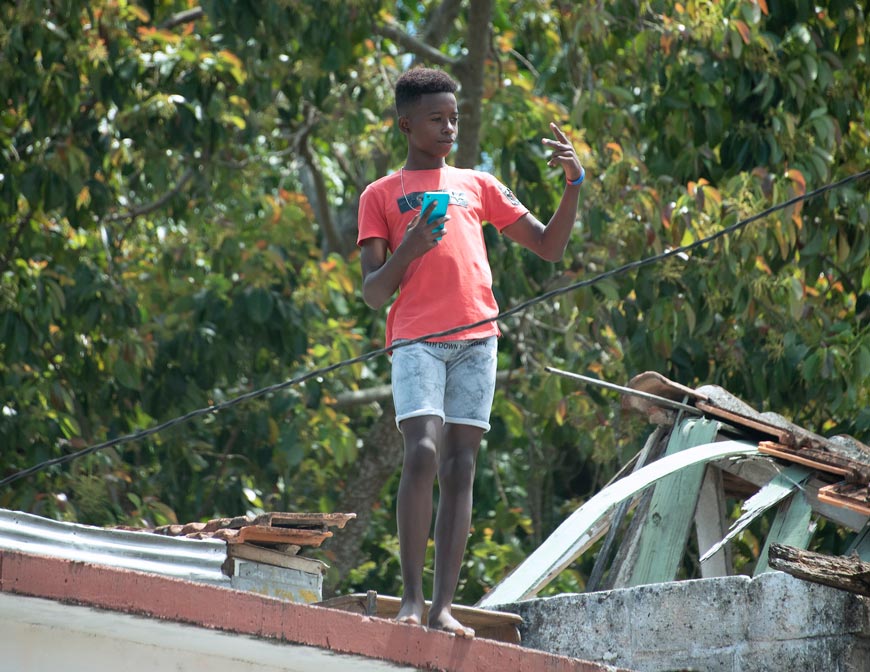 Cuban boy with phone on a rooftop (Кубинский мальчик с телефоном на крыше), March 2019