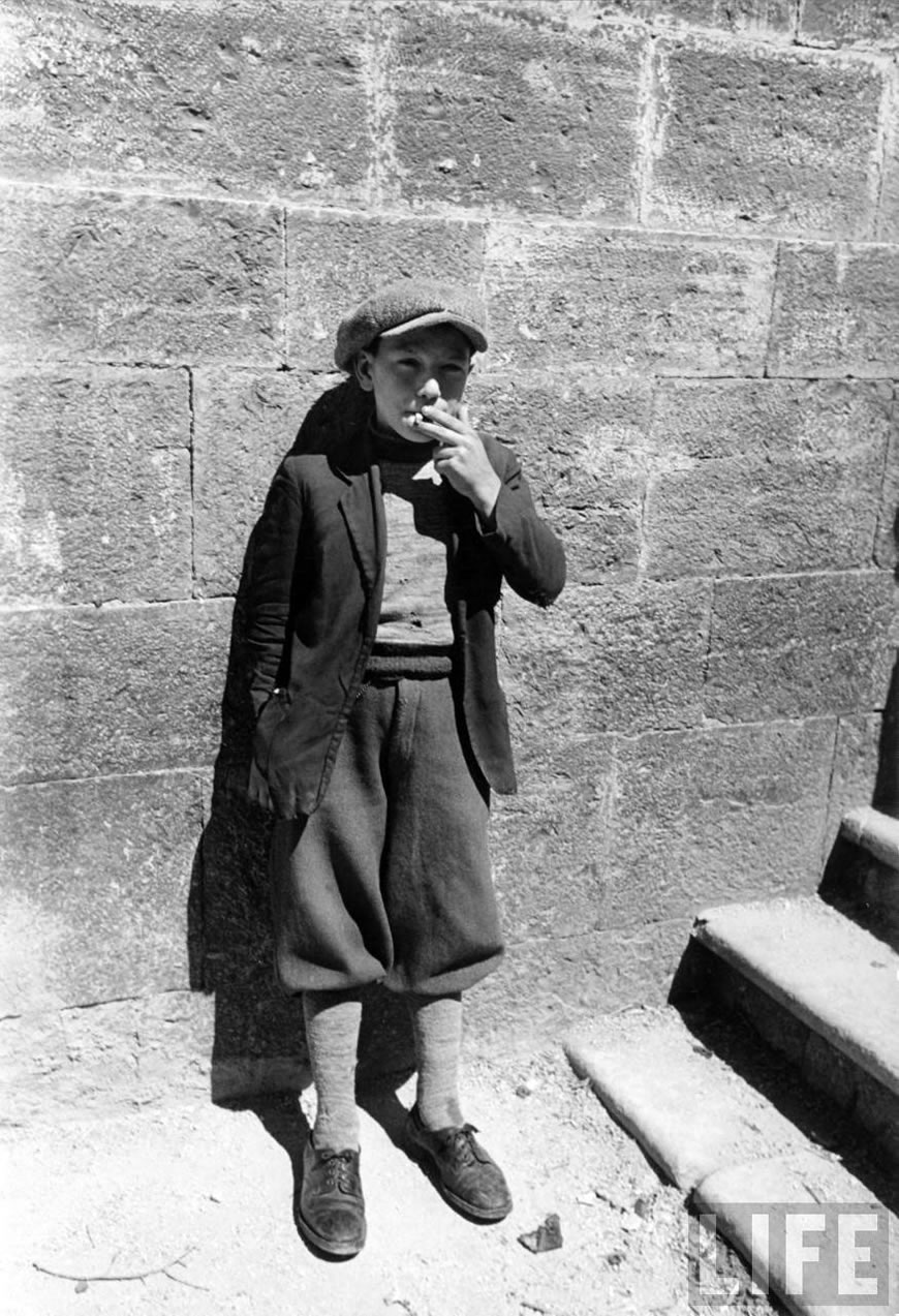 13-year-old boy smoking a cigarette butt (13-ти летний мальчик, курящий окурок), 1947