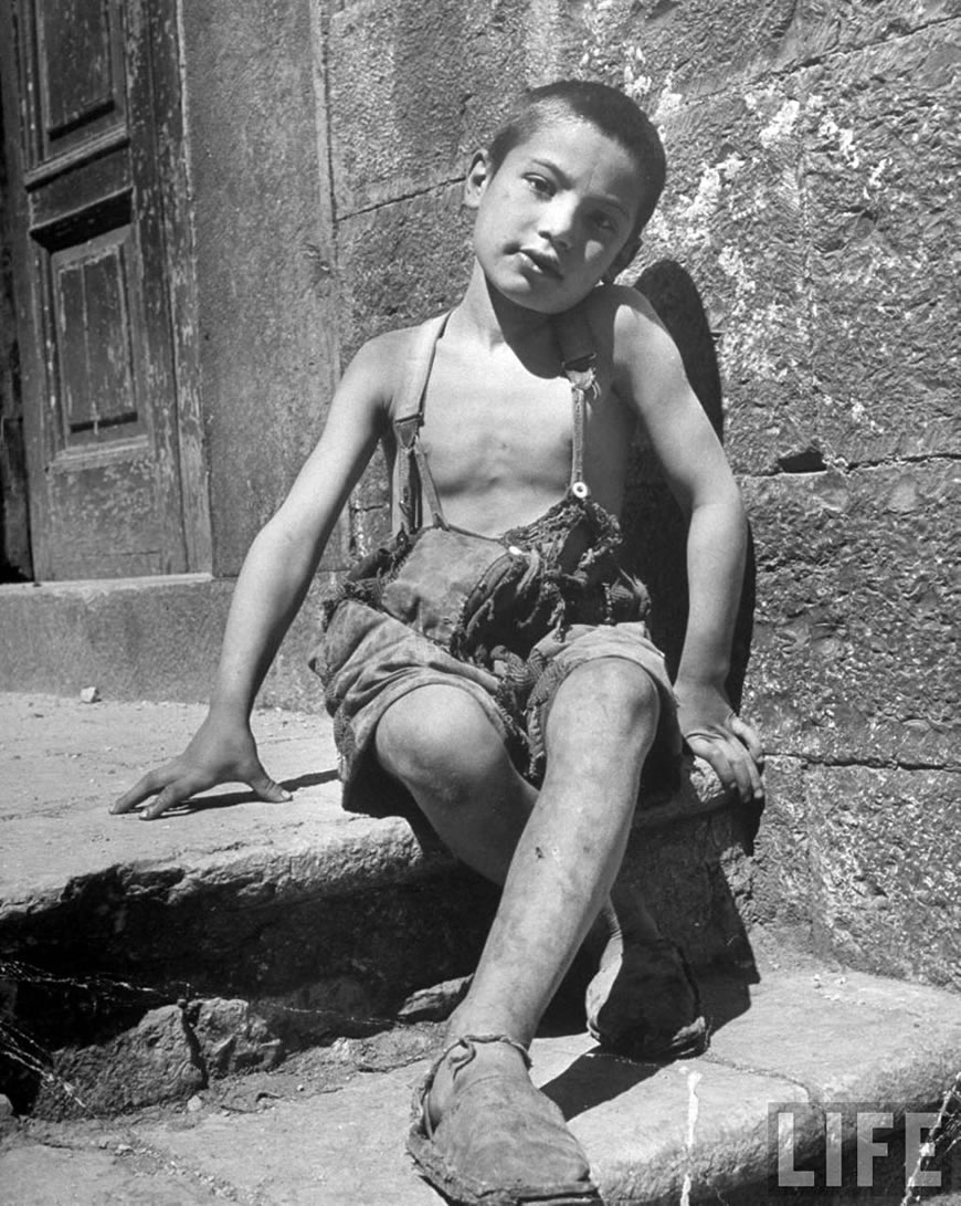 6-year-old boy wearing only a pair of patched and tattered shorts (6-ти летний мальчик, одетый только в заплатанные шорты), 1947