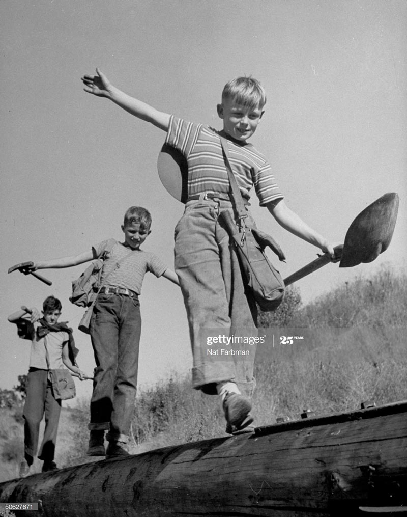 Boy paleontologists walking the rails on a pole lying on the ground (Мальчики-палеонтологи шагают по брусу на столбах, лежащих на земле), 1945