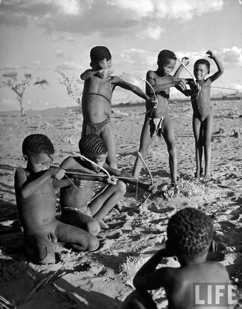 Bushman children practicing how to use a bow and arrow (Дети бушменов практикуются в стрельбе из лука), 1947