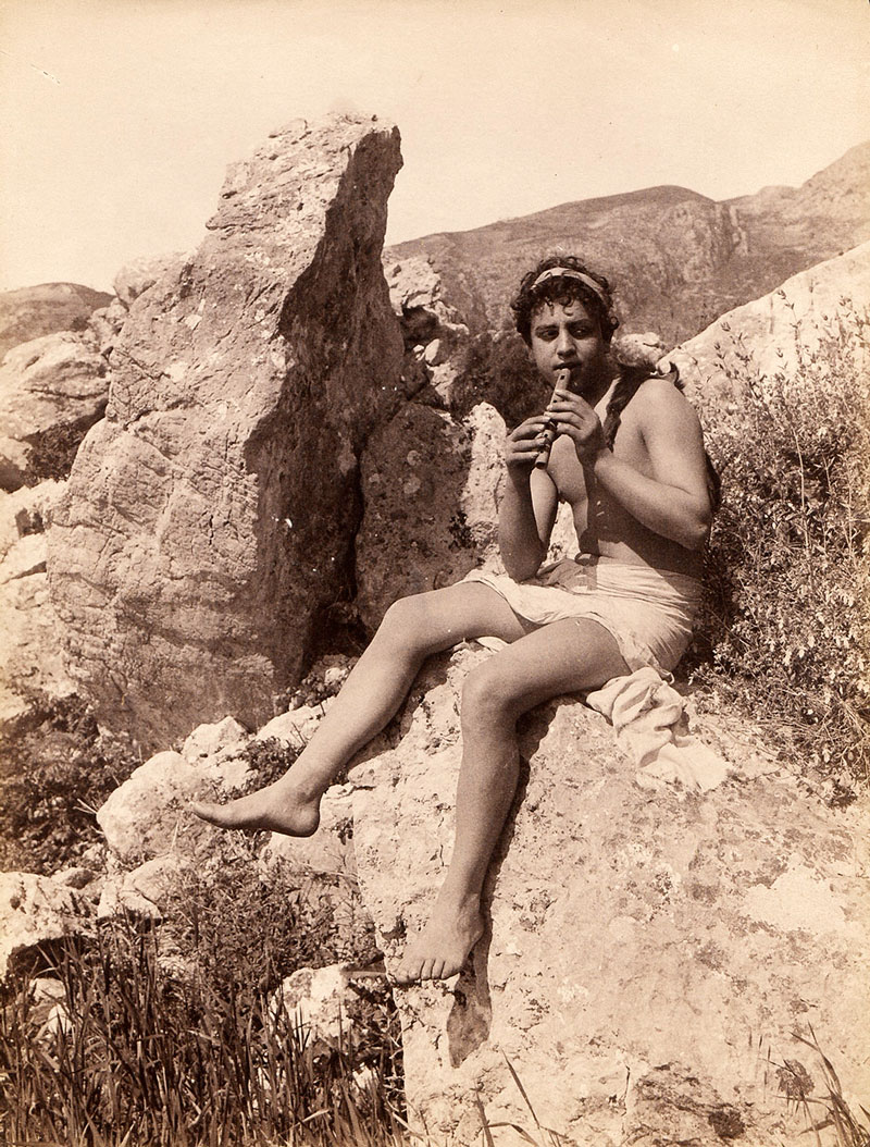 Young boy seated on rock playing the flute (Мальчик, сидящий на скале и играющий на флейте), 1890s