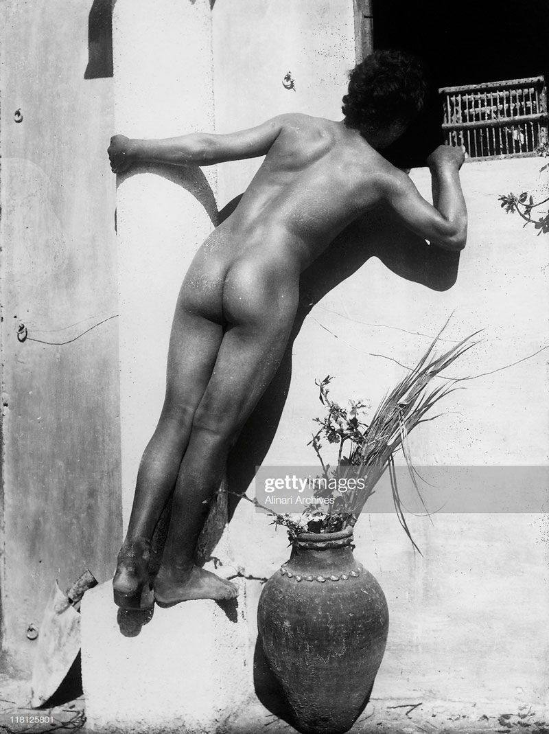 Naked young boy, turning the back, looks in a window (Нагой мальчик, повернувшийся задом, заглядывает в окно), c.1895