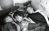 Homeless children sleep in an abandoned house