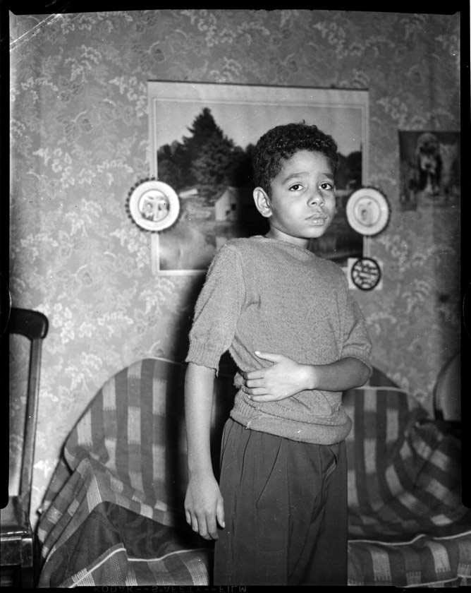 Boy holding his side in domestic interior (Мальчик держится за бок в интерьере дома), 1945-1970