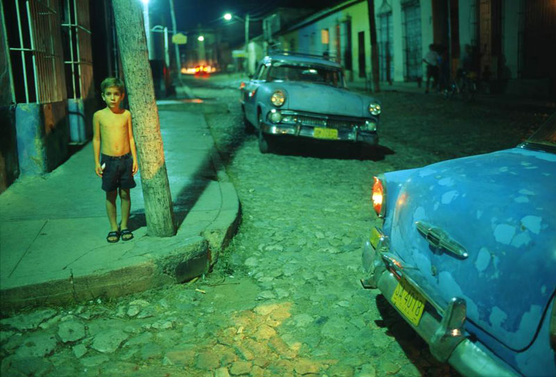 A young boy standing on a street corner (Мальчик стоит на углу улицы). Trinidad, Cuba, 1998