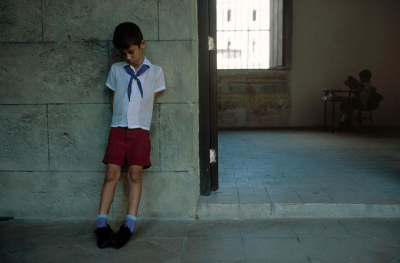 A boy hangs his head after being ejected from a class at church (Мальчик опустил голову, после того, как его выгнали из церковного класса). Trinidad, Havana, 1998