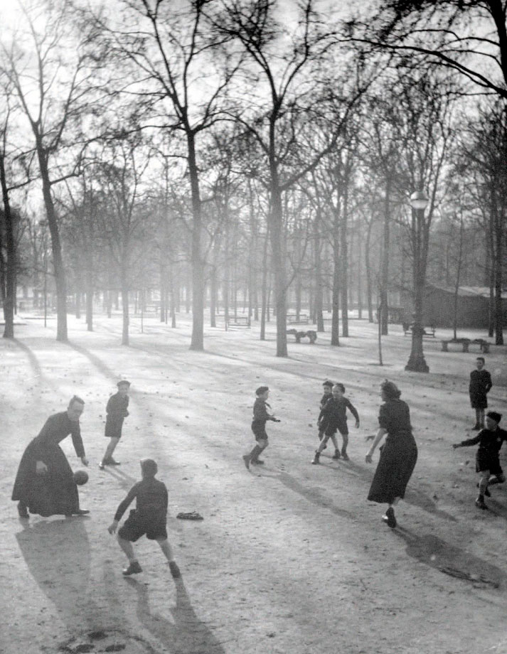 Garçons jouant à la balle avec leur professeur, jardin des (Мальчики играют в мяч со своим учителем в саду), 1951