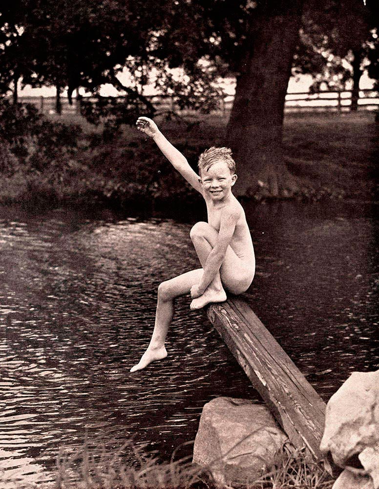 Portrait of boy sitting on wooden diving board besides lake (Портрет мальчика на доске у озера), c.1955