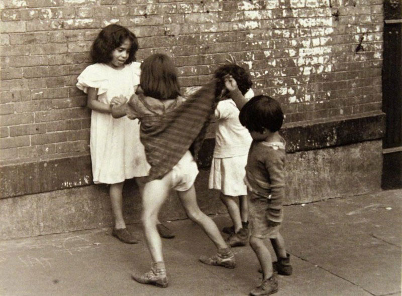 A boy lifting up a girl's dress in front of other children (Мальчик, задирающий платье девочки перед другими детьми), c.1942