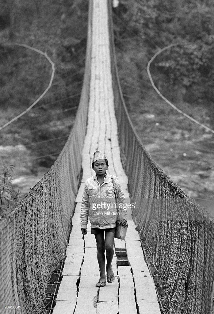 A boy on his way to school crossing a man-made wooden bridge (Мальчик на пути в школу пересекающий деревянный мост), 1989