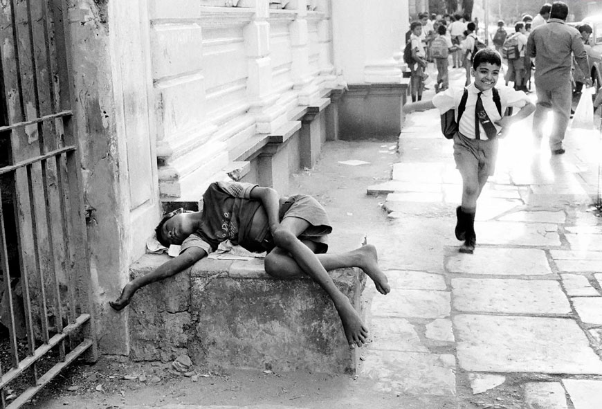 Farukh, a street child suffering from polio, sleeps outside Bharda School