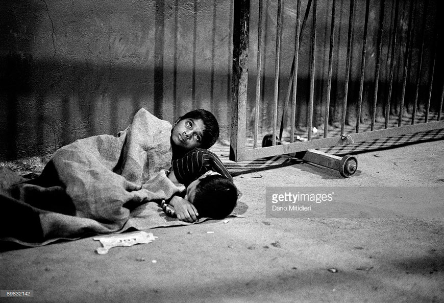 Street children Gangaram and Anu, about to fall asleep at the Victoria Terminus Station near a railtrack