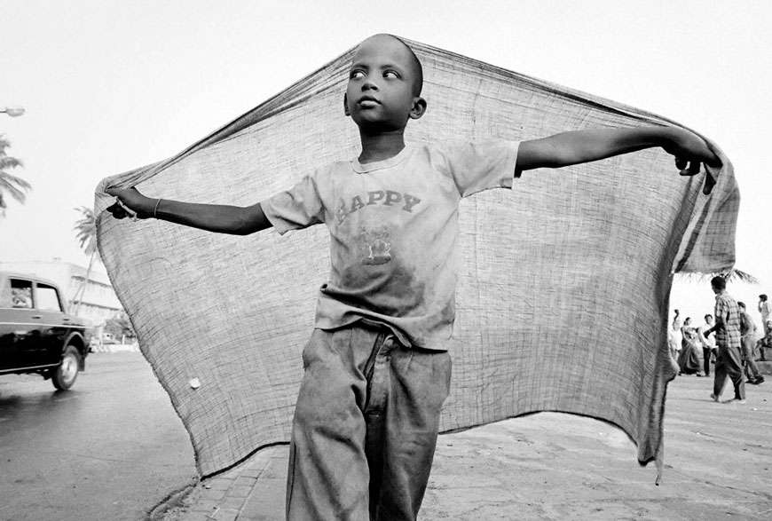 A street child playing on Chowpatti beach