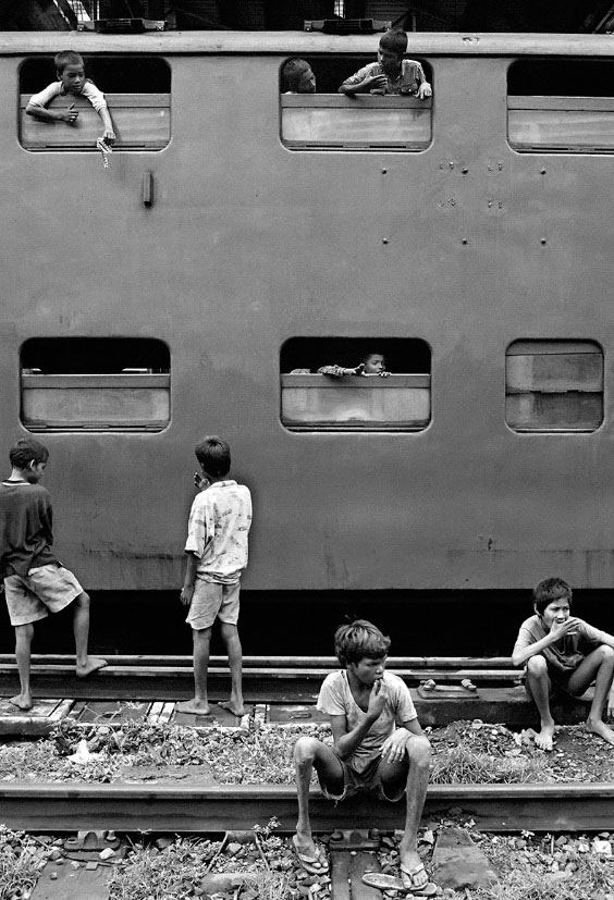 Street children from the VT gang playing on a stationary train at Victoria Terminus Station