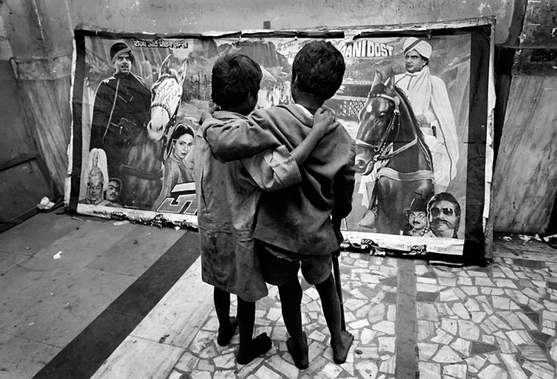 Two street children looking at a Hindi film poster in one of the many cinemas on Grant Road