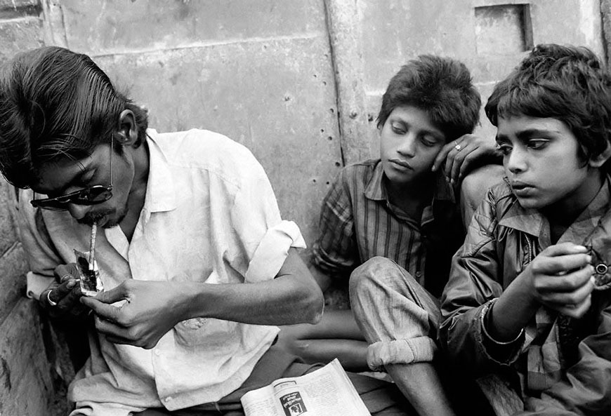 Sadik and Apser, both 12 years old from Bangalore, smoke brown sugar (an impure form of heroin) with the drug dealer who has just sold it to them