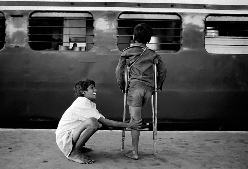 Street children waiting for leftovers outside the kitchen compartment of a train at Bombay Central Station