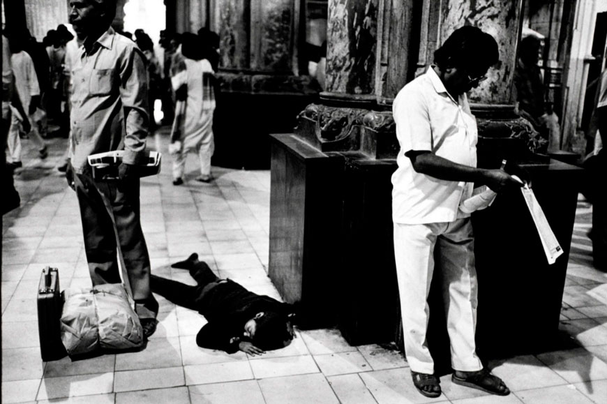 A street child steeps in the ticket hall of Victoria Terminus (VT)