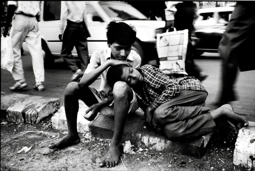 Amir, suffering from stomach worms, is comforted by one of his friends outside VT station