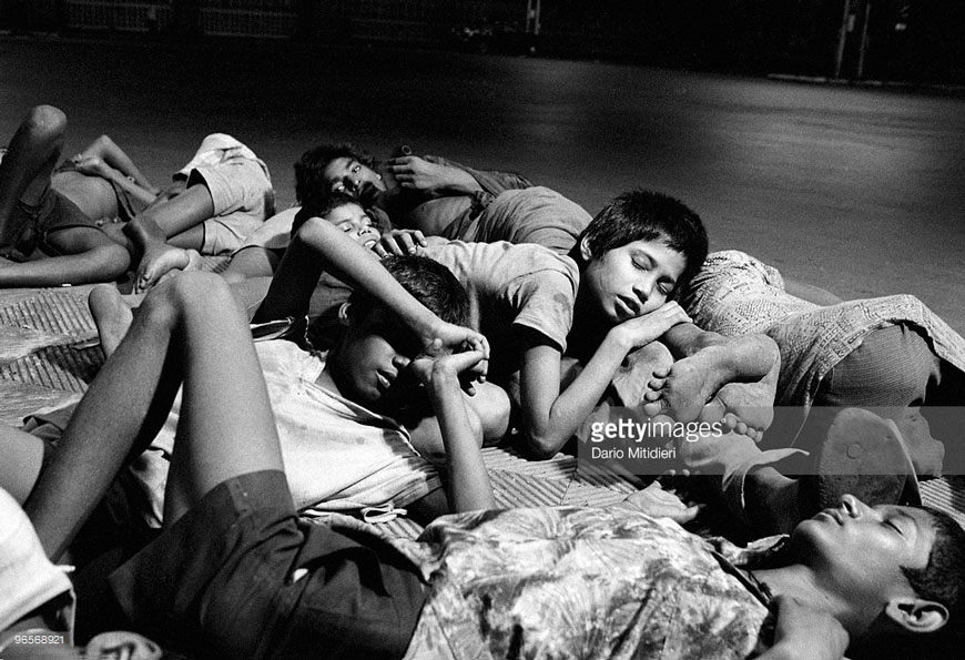 Street children from the Victoria Terminus gang sleep outside the station