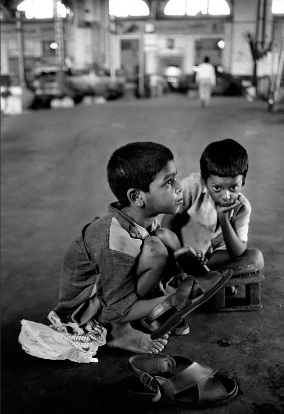 Street children Babu and Raju earn money by shining shoes at Bombay Central train station