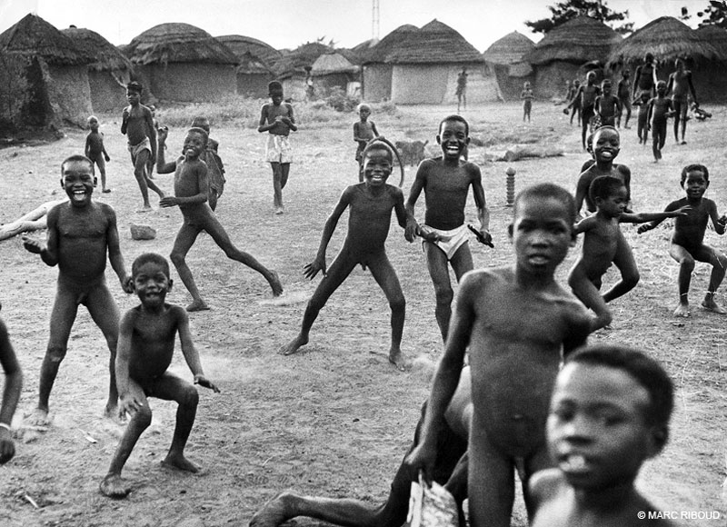 North of Ghana, in a village cut of the modern world, the cheerful and bare children run up at the arrival of their first westerner, 1960