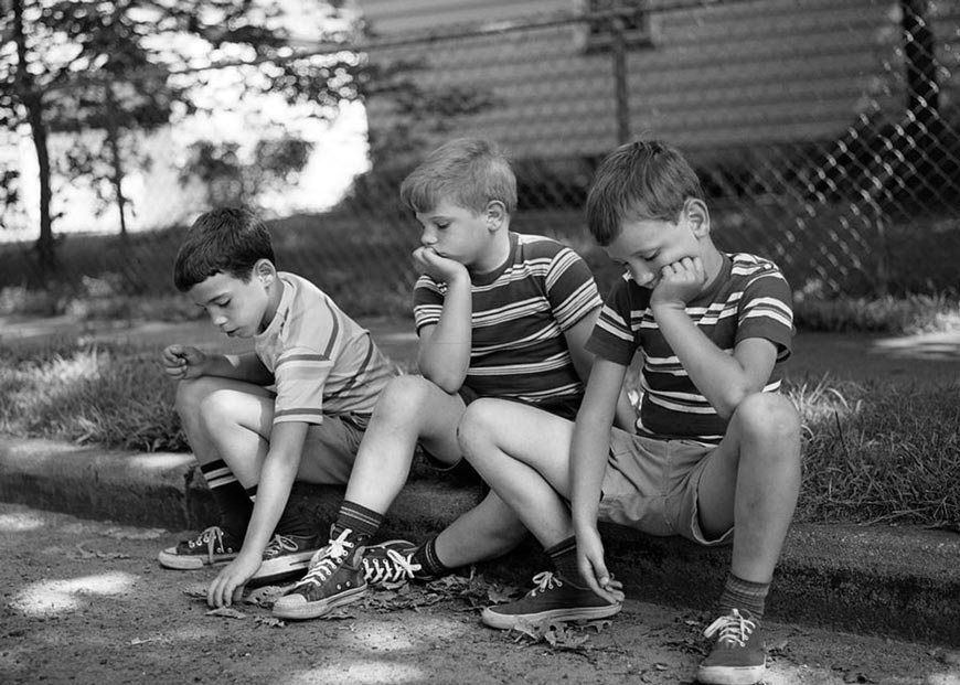 Three bored boys sitting on curb (Трое скучающих мальчиков, сидящих на бордюре), 1970s