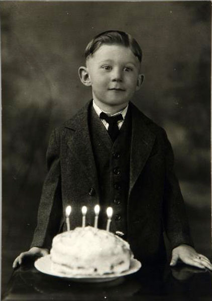 Young boy in suit with birthday cake (Мальчик в косюме с тортом на день рождения), c.1950s