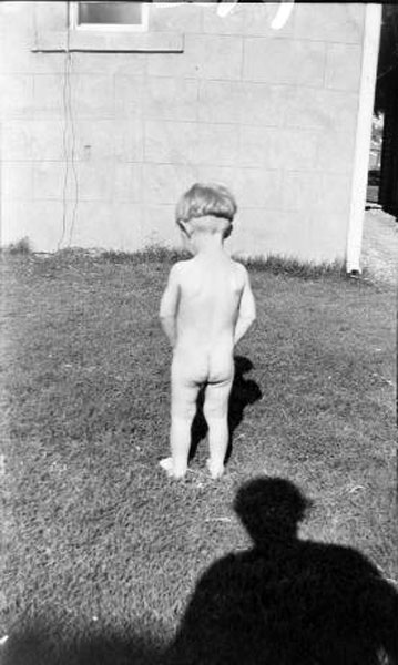 Nude young boy standing on grass, seen from behind (Голый мальчик, стоящий на траве, вид сзади), c.1950s