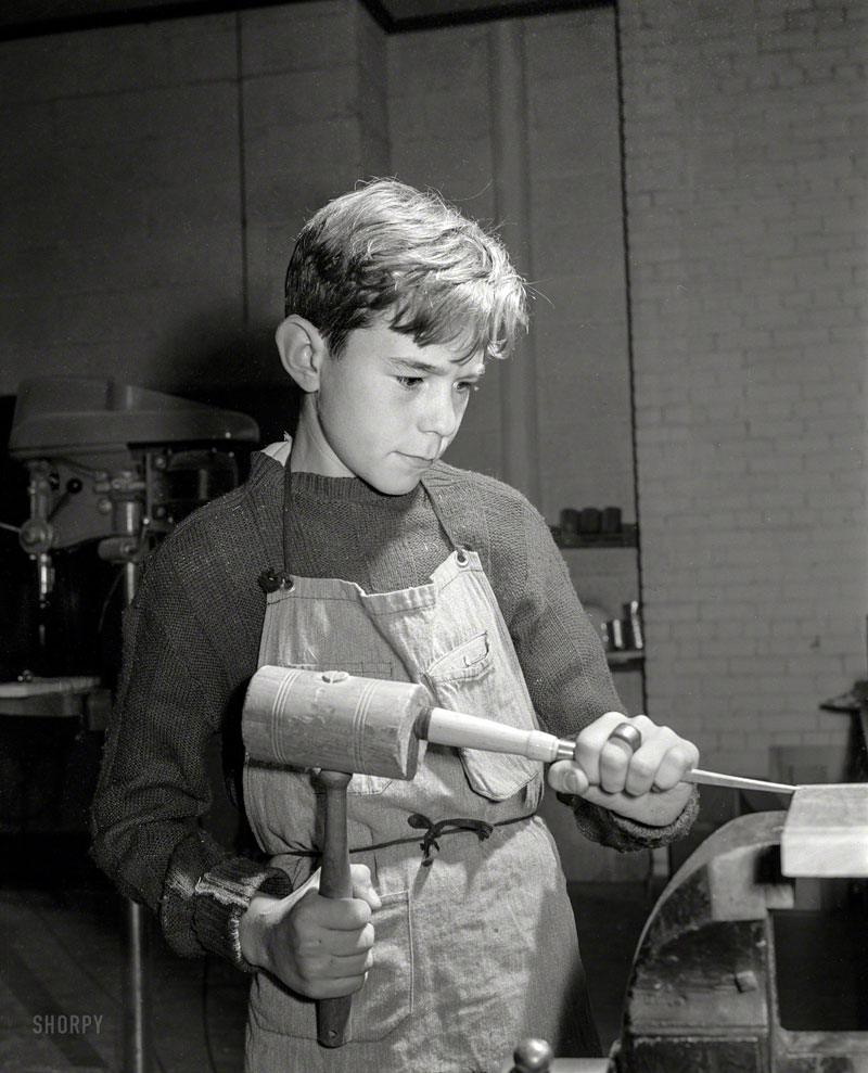 Boy grooving wood in shop class at homestead school (Мальчик, работающий с деревом в мастерской при сельской школе), Dec.1941