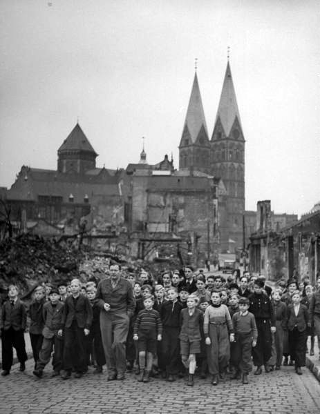 American GI leading German boys on tour of city as part of a Boys Club outing