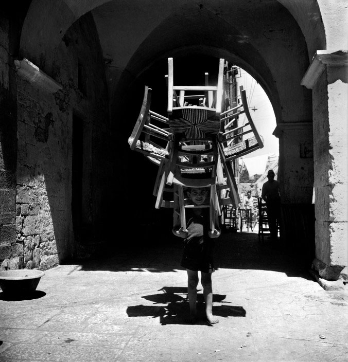 A boy transports chairs from the carpenter's workshop to the vernishing shop (Мальчик, переносящий стулья из столярной мастерской в лакировочный цех), 1948